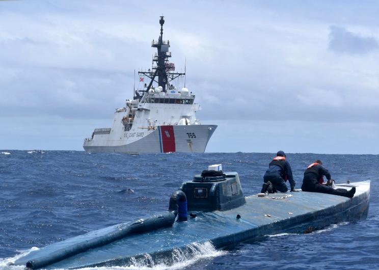 Crew members of the U.S. Coast Guard Cutter Munro inspect a self-propelled semi-submersible suspected drug smuggling vessel in international waters of the Eastern Pacific Ocean, on June 19, 2019. (U.S. Coast Guard Photo)