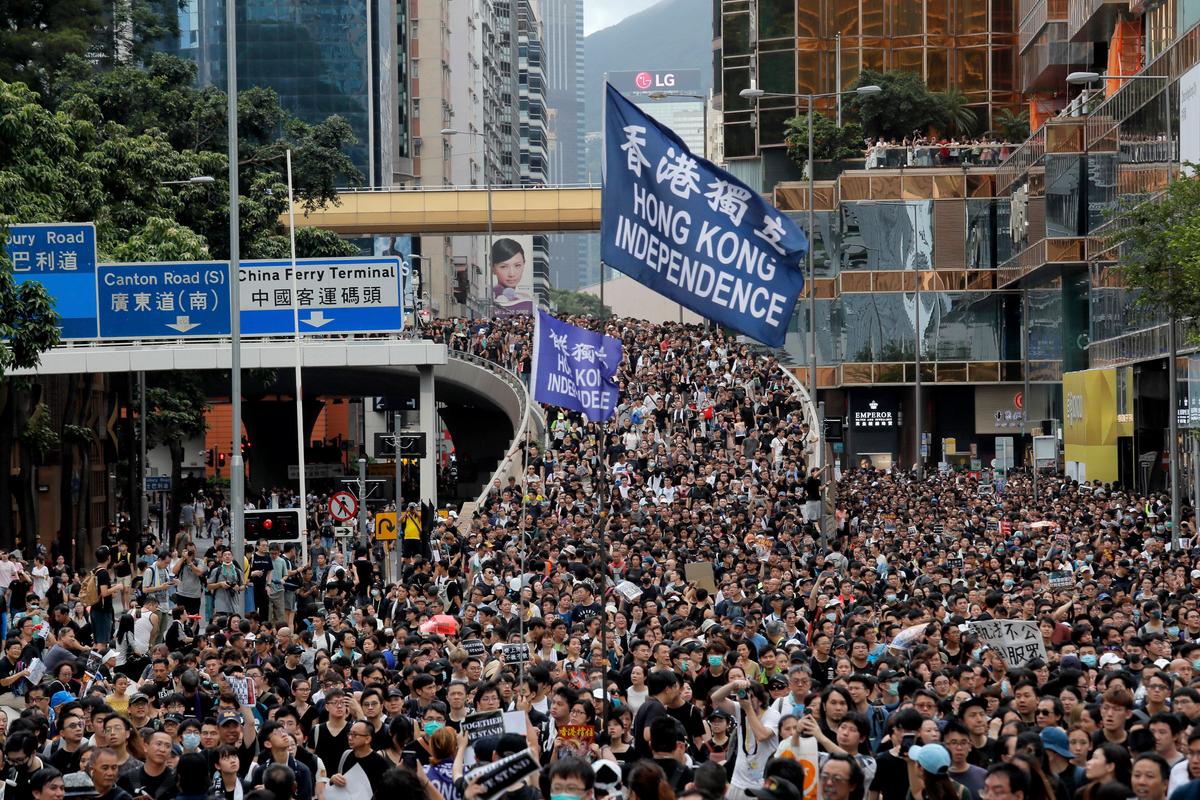 Protesters march with a flag calling for Hong Kong independence in Hong Kong on July 7, 2019. Thousands of people, many wearing black shirts and some carrying British flags, were targeting a mainland Chinese audience as a month-old protest movement showed no signs of abating. (Kin Cheung/AP)