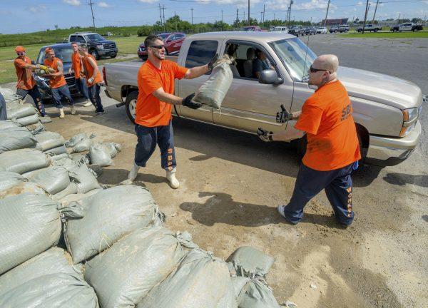St. Bernard Parish Sheriff's Office inmate workers move free sandbags for residents in Chalmette, La., on July 11, 2019. (Matthew Hinton/AP)