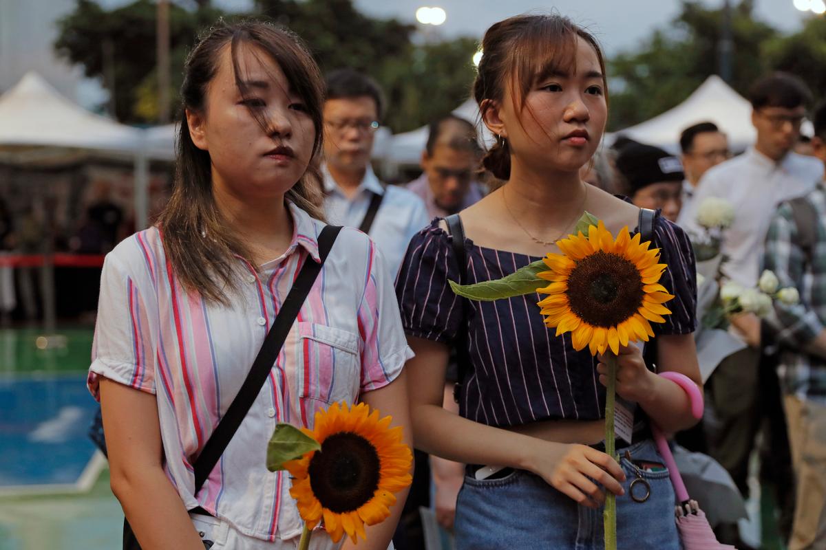 Attendees take part in a public memorial for Marco Leung, 35-year-old man, who fell to his death weeks ago after hanging a protest banner against an extradition bill, in Hong Kong on July 11, 2019. The parents of a Hong Kong man who plunged to his death after putting up banners against divisive extradition bills have urged young people to stay alive to continue their struggle. (Kin Cheung/AP)