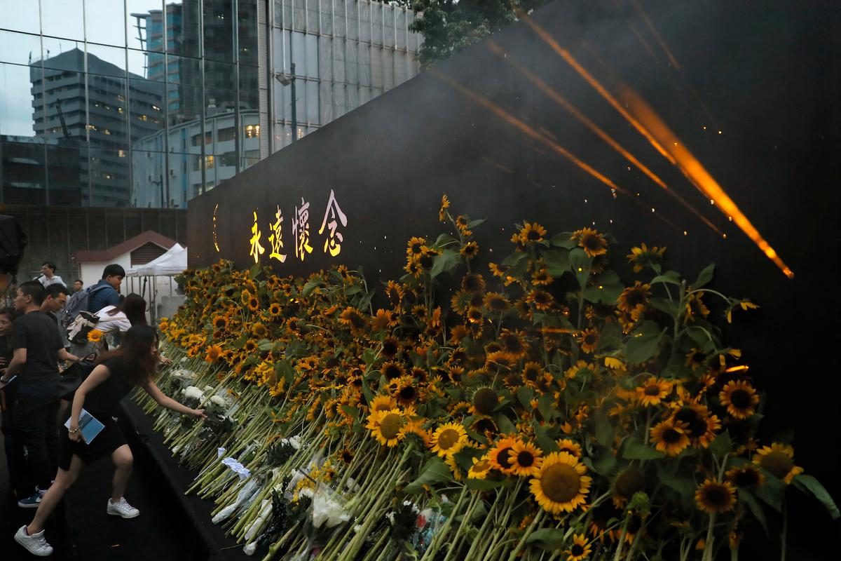 Attendees take part in a public memorial for Marco Leung, a 35-year-old man who fell to his death weeks ago after hanging a protest banner against an extradition bill, in Hong Kong, China on July 11, 2019. (Kin Cheung/AP)