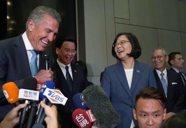 Taiwan's President Tsai Ing-wen (2R) and USTBC chairman/NASDAQ president Michael Splinter walk past security to talk with the press before they attend a Taiwan-U.S. business summit in midtown New York on July 12, 2019. (Timothy A. Clary/AFP/Getty Images)