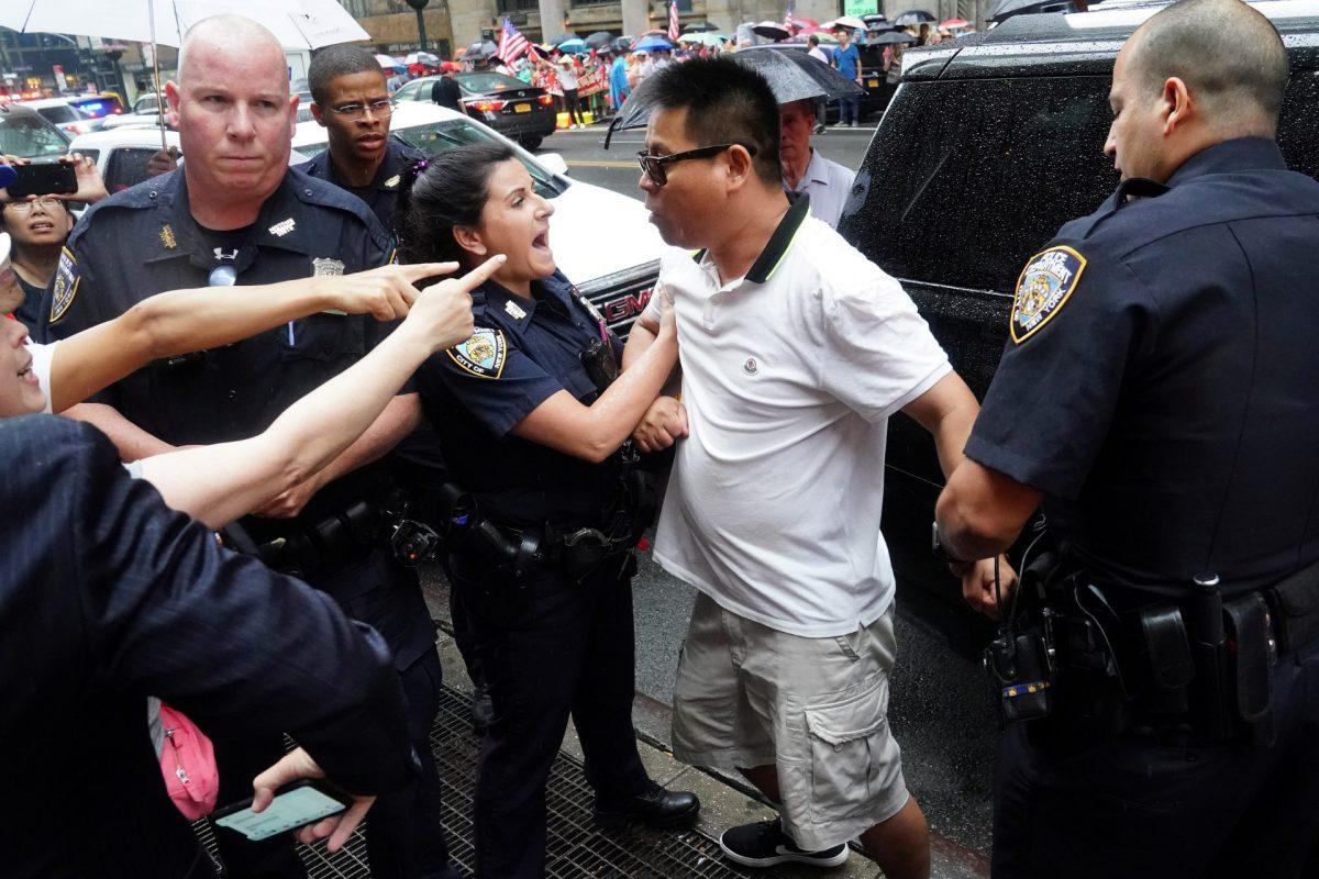 Police officers detain a man after scuffles broke out outside Grand Hyatt hotel, where Taiwan's President Tsai Ing-wen is supposed to stay during her visit to the U.S., in New York City, on July 11, 2019. (Carlo Allegri/Reuters)