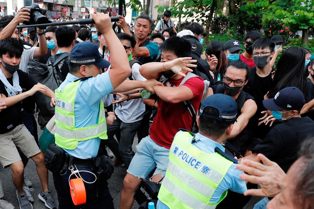 Police swing their batons at protesters as they try to disperse pro-democracy activists after a march at Sheung Shui, a town at the city's border in Hong Kong, China on July 13, 2019. (Tyrone Siu/Reuters)