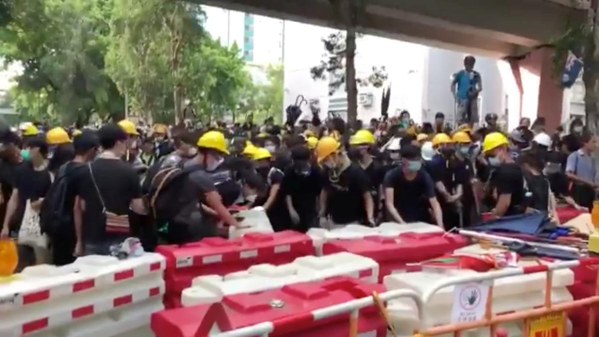 Demonstrators stand near road dividers during a clash with police in Sheung Shui, Hong Kong, China on July 13, 2019, in this still image taken from a social media video. (Aaron Mc Nicholas via Reuters)