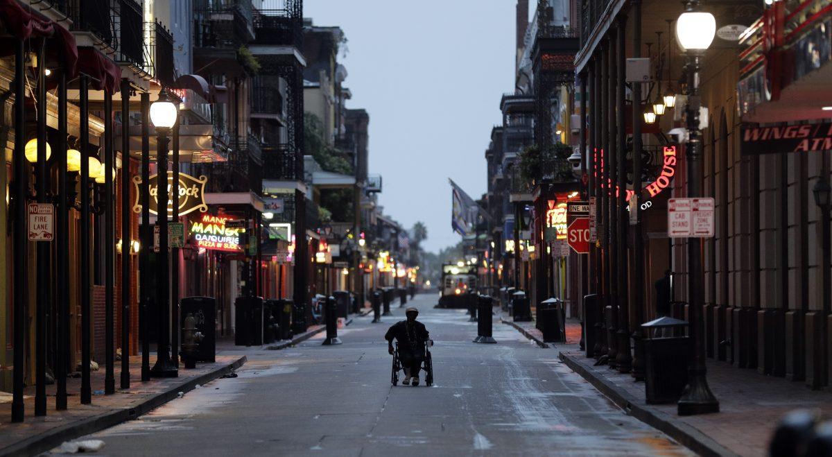 A man in a wheelchair makes his way down Bourbon Street in the French Quarter on July 13, 2019, in New Orleans, as Tropical Storm Barry nears landfall. (AP Photo/David J. Phillip)