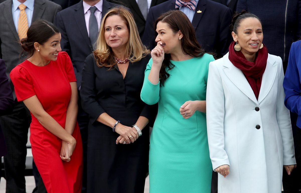 (L-R) Representatives-elect Alexandria Ocasio-Cortez (D-N.Y.), Debbie Mucarsel-Powell (D-Fla.) Abby Finkenauer (D-Iowa), and Sharice Davids (D-Kan.) join with other newly elected members of the House of Representatives for an official class photo of new House members at the U.S. Capitol in Washington on Nov. 14, 2018. (Win McNamee/Getty Images)