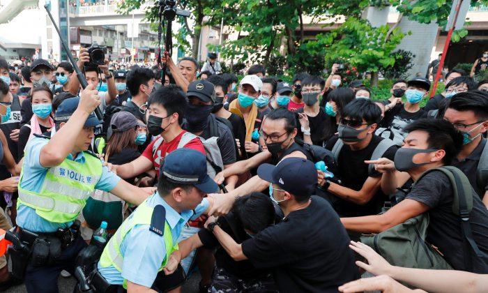 Hong Kong Protesters and Police Clash as Demonstrations Target Chinese Traders