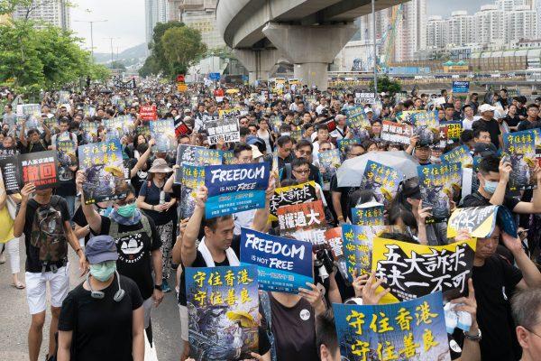 Protesters take part in a march against a controversial extradition bill on July 14, 2019 in Sha Tin district, Hong Kong. (Li Yi/The Epoch Times)