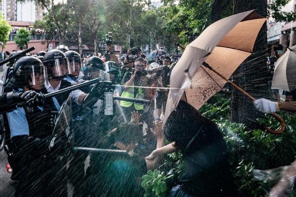 Police officers use pepper spray to disperse protesters after a rally in Sheung Shui district of Hong Kong on July 13, 2019. (Anthony Kwan/Getty Images)