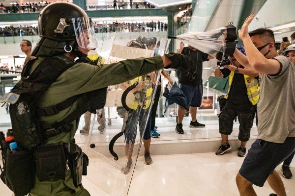 Riot police chase protesters through a shopping mall as they clash with protesters after taking part in a pro-democracy march in the Sha Tin district of Hong Kong on July 14, 2019. (Chris McGrath/Getty Images)