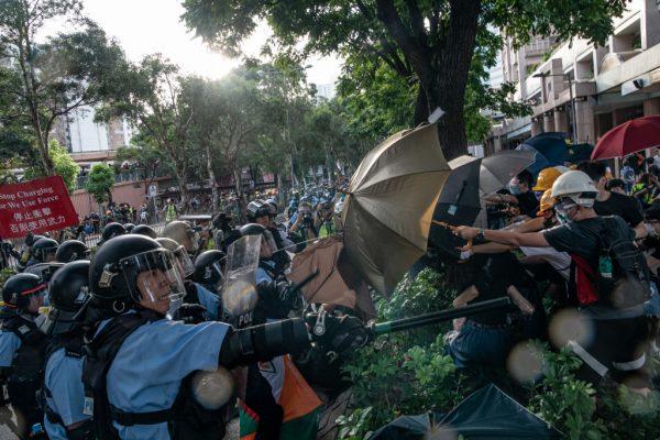 Police officers use pepper spray to disperse protesters after a rally in theSheung Shui district of Hong Kong on July 13, 2019. (Anthony Kwan/Getty Images)
