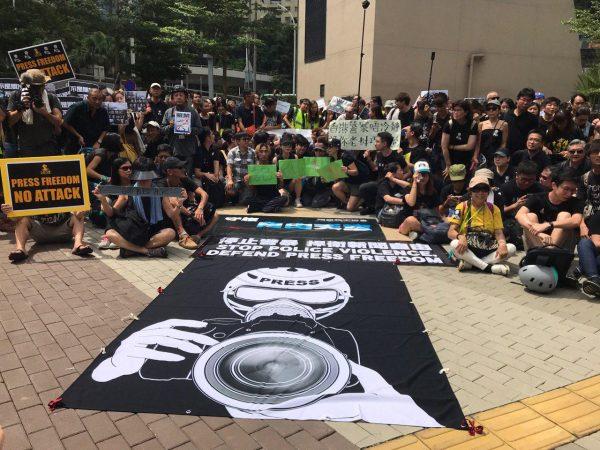 Protesters gather in front of a banner that reads “Stop Police Violence, Defend Press Freedom” at a rally in Admiralty, Hong Kong on July 14, 2019. (Li Yi/The Epoch Times)