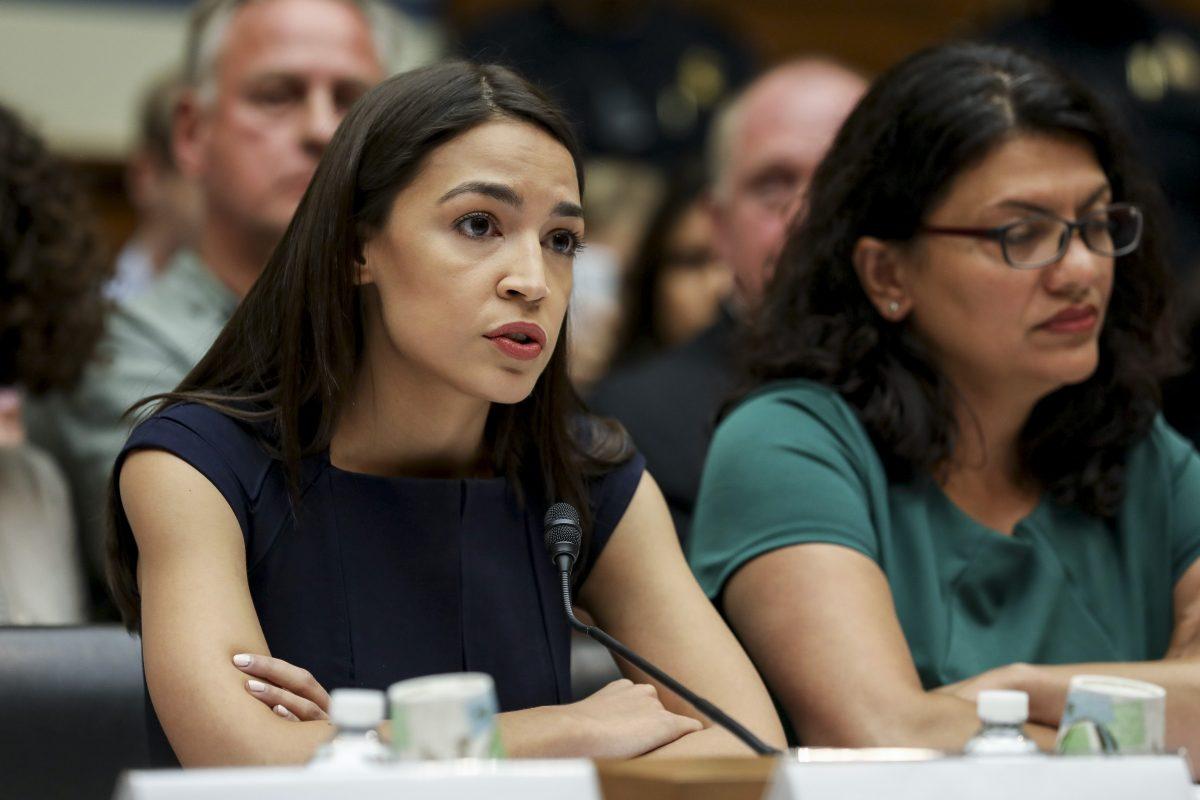 L-R: Rep. Alexandria Ocasio-Cortez (D.N.Y.) and Rashida Tlaib (D-Mich.), members of the Democratic Socialists of America, at a House hearing in front of the Committee on Oversight and Reform, in Washington on July 12, 2019. (Charlotte Cuthbertson/The Epoch Times)