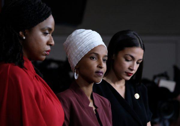 Reps. Ayanna Pressley (D-Mass.), Ilhan Omar (D-Minn.), and Alexandria Ocasio-Cortez (D-N.Y.) listen during a news conference at the U.S. Capitol in Washington, on July 15, 2019. (Alex Wroblewski/Getty Images)