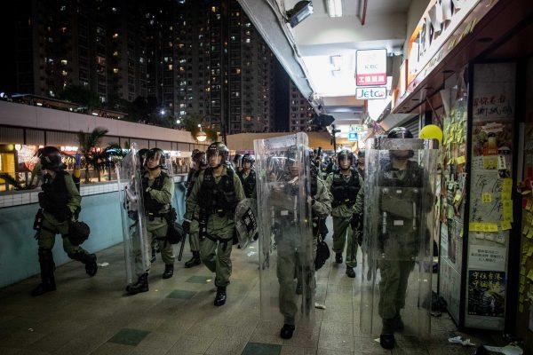 Riot police chase protesters through a shopping mall as they clash with protesters after taking part in a pro-democracy march in the Sha Tin district of Hong Kong on July 14, 2019. (Chris McGrath/Getty Images)