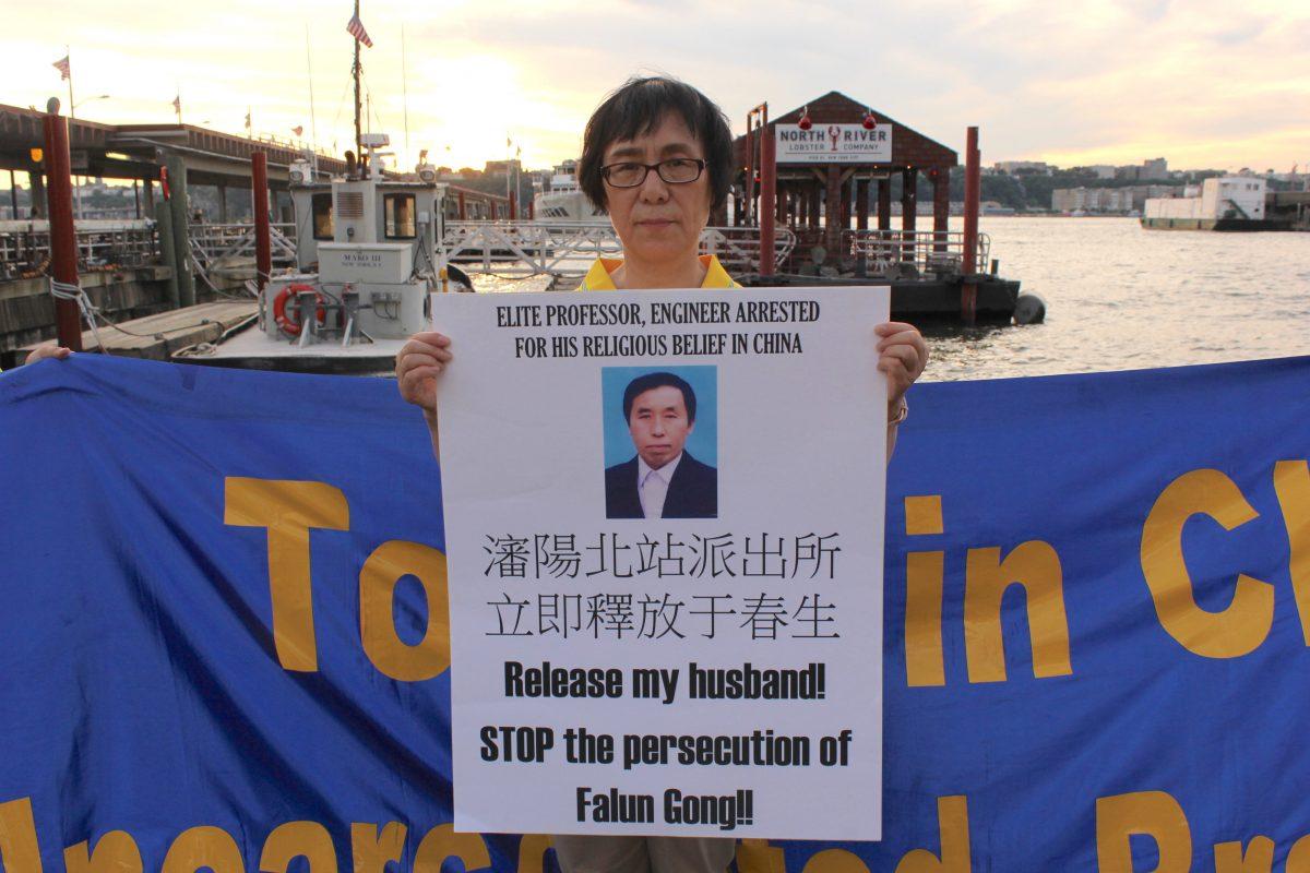 Xiao Yanbing holds a sign calling for the release of her husband, Yu Chunsheng, who has been held incommunicado since June, in New York on July 15, 2019. (Eva Fu/The Epoch Times)