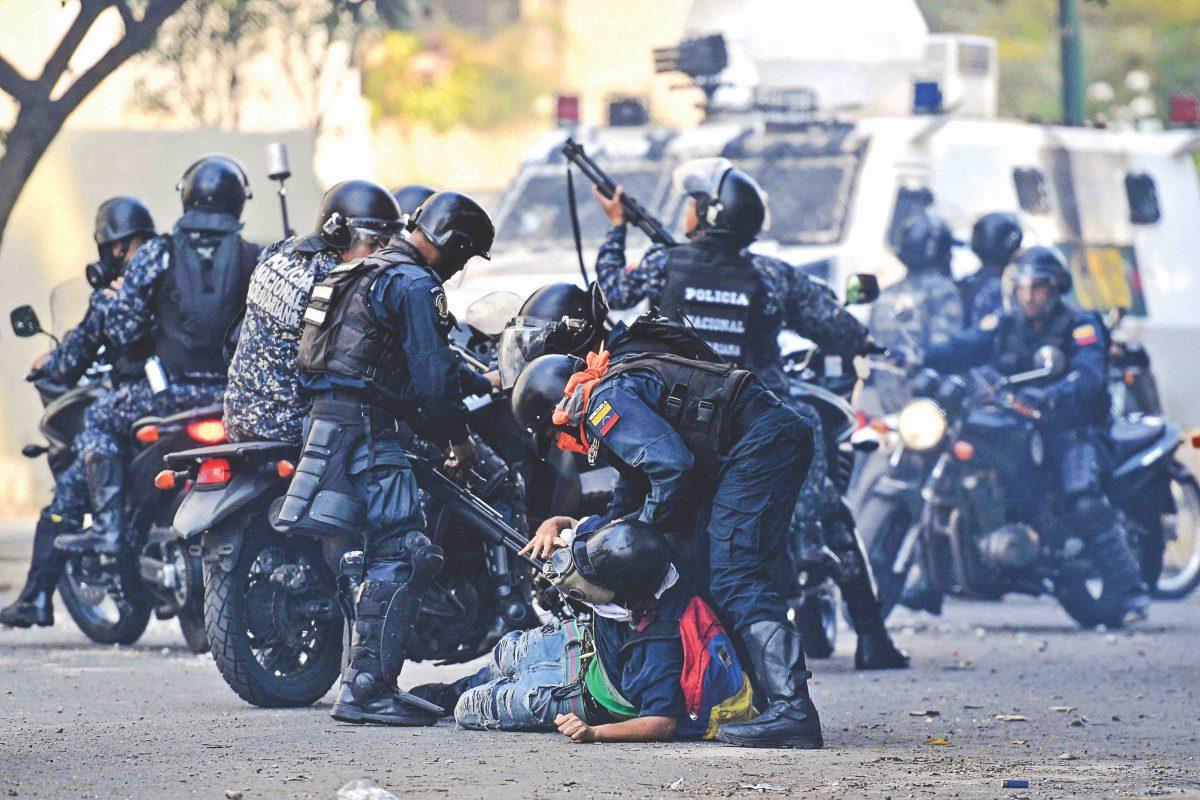 An anti-Maduro protester is detained by security forces during clashes in Caracas on May 1, 2019. (Federico Parra/AFP/Getty Images)