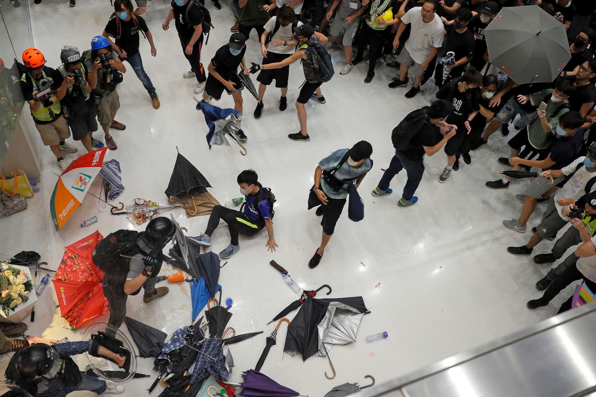 Protesters and policemen clash inside a shopping mall in Sha Tin District in Hong Kong on July 14, 2019. (Kin Cheung/AP)