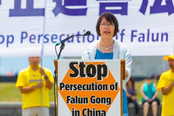 Dr. Yuhua Zhang, whose husband Zhenyu Ma is imprisoned in China, speaks at the 19th anniversary of the beginning of the persecution of Falun Gong on July 20, 1999, at the Washington Monument in Washington on July 19, 2018. (Mark Zou/The Epoch Times)