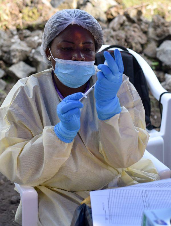 A Congolese health worker prepares to administer an Ebola vaccine to a man at the Himbi Health Centre in Goma, Democratic Republic of Congo, July 17, 2019. (Olivia Acland/Reuters)