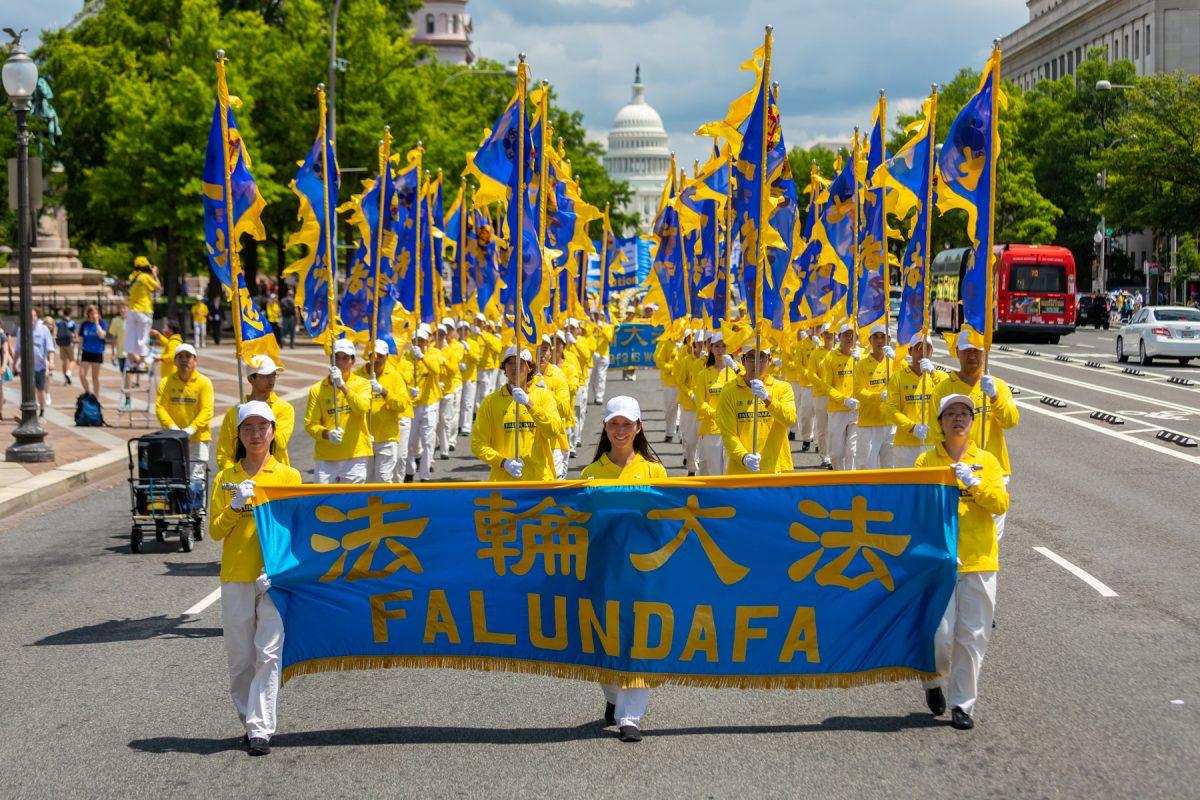 Falun Gong practitioners take part in a parade commemorating the 20th anniversary of the persecution of Falun Gong in China, in Washington on July 18, 2019. (Mark Zhou/The Epoch Times)