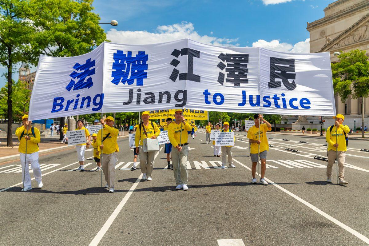 Falun Gong practitioners take part in a parade commemorating the 20th anniversary of the persecution of Falun Gong in China, in Washington on July 18, 2019. (Mark Zou/The Epoch Times)