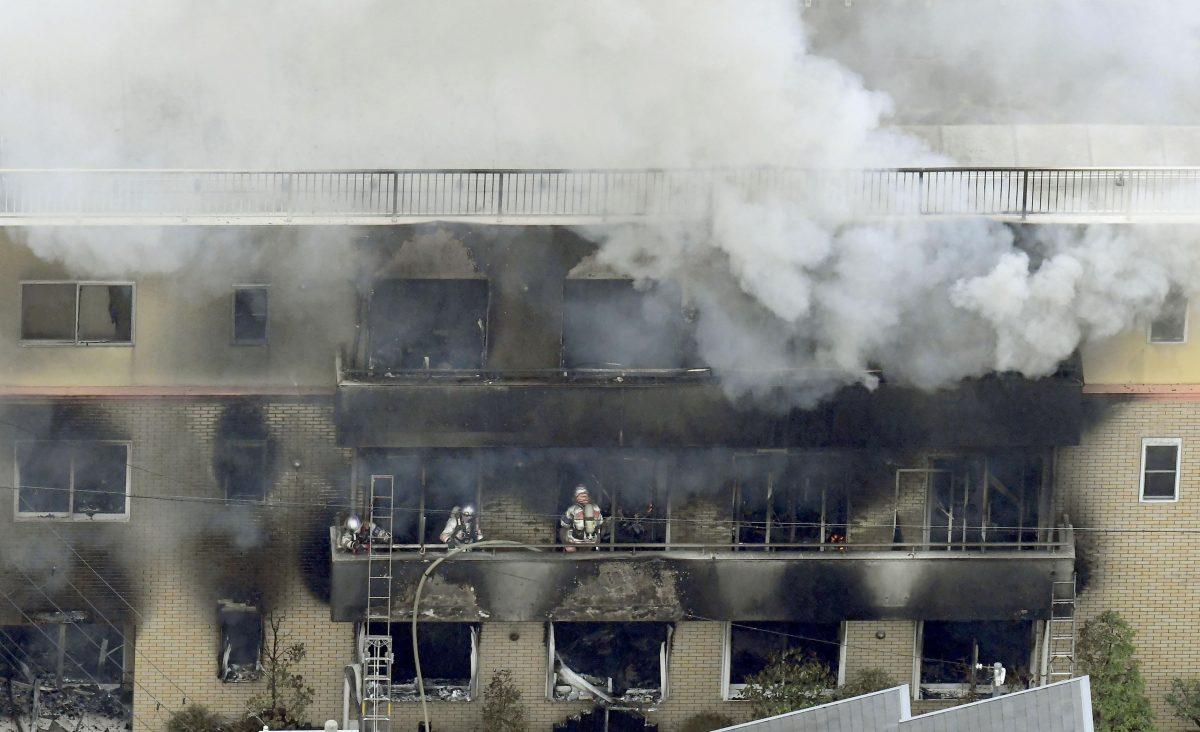 Firefighters work as smoke billows from a three-story building of Kyoto Animation in a fire in Kyoto, western Japan, on July 18, 2019. (Kyodo News/AP)