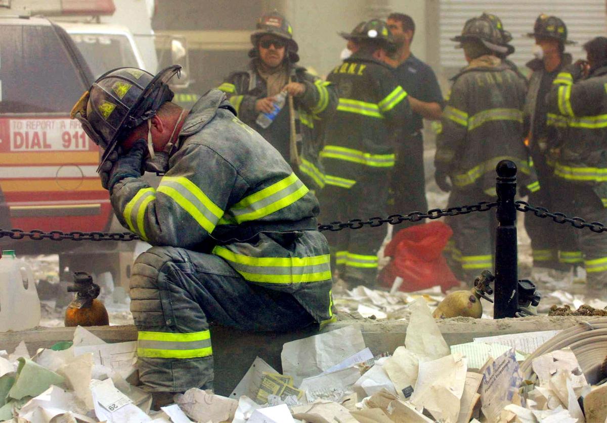A firefighter breaks down after the World Trade Center buildings collapsed after two hijacked airplanes slammed into the twin towers in a terrorist attack on Sept. 11, 2001. (Mario Tama/Getty Images)