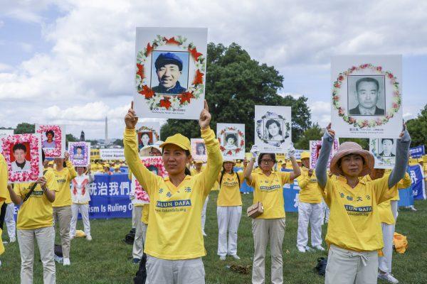 Falun Gong practitioners take part in a rally commemorating the 20th anniversary of the persecution of Falun Gong in China, on the West Lawn of Capitol Hill on July 18, 2019. (Samira Bouaou/The Epoch Times)
