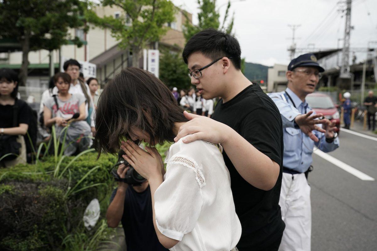 A woman prays to honor the victims of the fire at the Kyoto Animation Studio building, in Kyoto, Japan, on July 19, 2019. (Jae C. Hong/AP Photo)