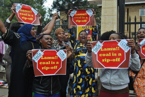 A group of women celebrates the court ruling against the coal plant outside the gate of the Supreme Court of Kenya on June 26, 2019. (Dominic Kirui for The Epoch Times)
