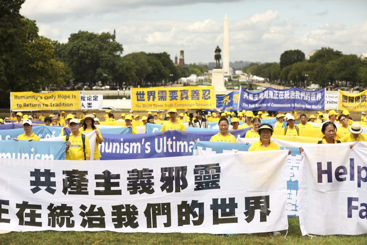 Falun Gong practitioners take part in a rally commemorating the 20th anniversary of the persecution of Falun Gong in China, on the West Lawn of Capitol Hill on July 18, 2019. (Samira Bouaou/The Epoch Times)