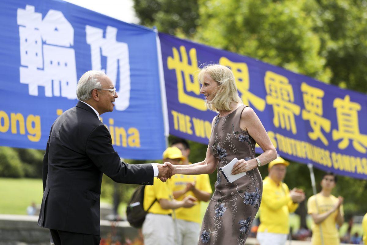 Wendy Wright, president at Christian Freedom International, shakes hands with Alan Adler, president of Friends of Falun Gong at a rally commemorating the 20th anniversary of the persecution of Falun Gong in China, on the West lawn of Capitol Hill in Washington on July 18, 2019. (Samira Bouaou/The Epoch Times)