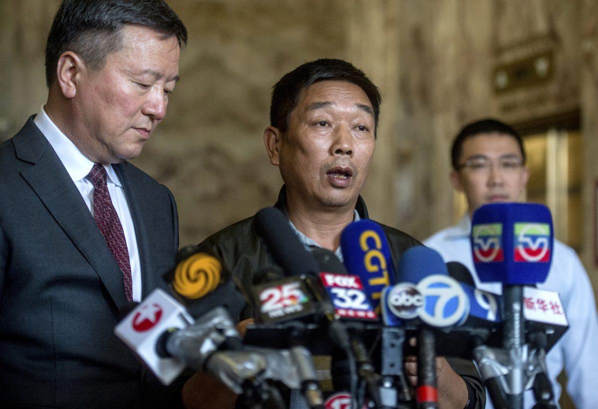 Ronggao Zhang (C), father of murdered University of Illinois visiting scholar Yingying Zhang, speaks to the media in Chinese during a news conference at the U.S. Federal Courthouse in Peoria, Ill., on July 18, 2019. (Matt Dayhoff/Journal Star via AP)