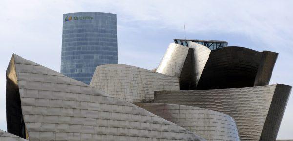 The Iberdrola Tower building (Iberdrola energy company's headquarters) is seen behind the Guggenheim Bilbao museum, in the Northern Spanish Basque city of Bilbao, on Feb. 21, 2012. (Rafa Rivas/AFP/Getty Images)