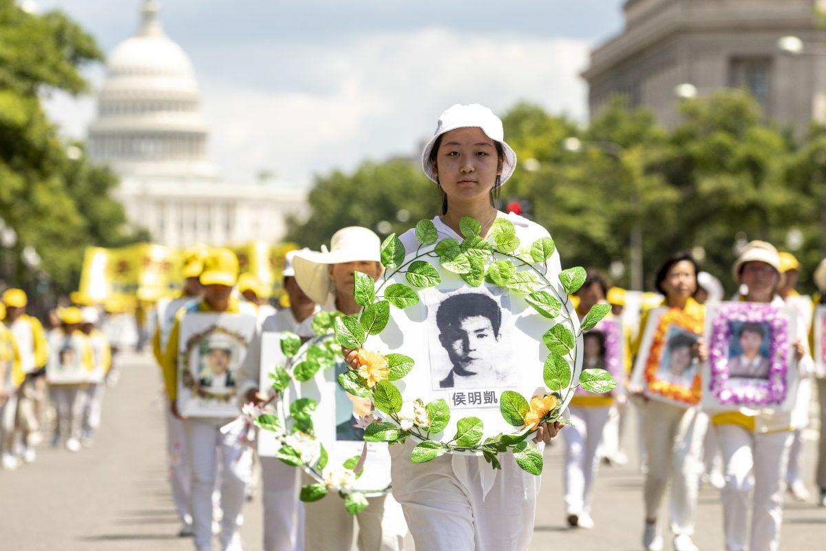 Falun Gong practitioners march from the U.S. Capitol to the Washington Monument commemorating the 20th anniversary of the persecution of Falun Gong in China, in Washington on July 18, 2019. (Samira Bouaou/The Epoch Times)