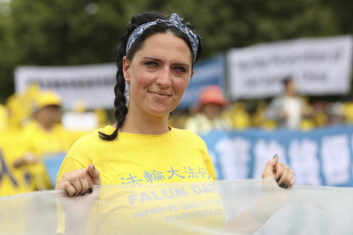 Falun Gong practitioners take part in a rally commemorating the 20th anniversary of the persecution of Falun Gong in China, on the West Lawn of Capitol Hill on July 18, 2019. (Samira Bouaou/The Epoch Times)