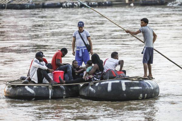 A group of Africans from Angola and Congo illegally arrive in Mexico after crossing the Suchiate River on tube rafts from Tecun Uman, Guatemala, near Hidalgo City, Mexico, on June 27, 2019. (Charlotte Cuthbertson/The Epoch Times)