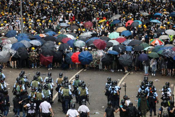 Protesters face off with police during a rally against a controversial extradition law proposal outside the government headquarters in Hong Kong on June 12, 2019. (DALE DE LA REY/AFP/Getty Images)
