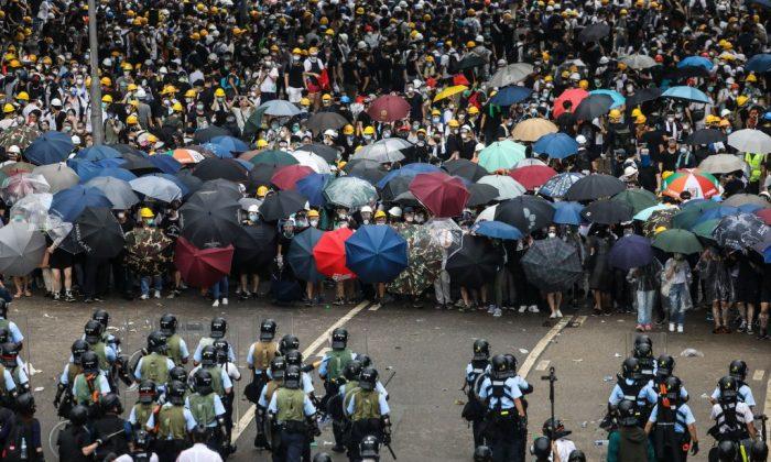 Protesters face off with police during a rally against a controversial extradition law proposal outside the government headquarters in Hong Kong on June 12, 2019. (Dale De La Rey/AFP/Getty Images)