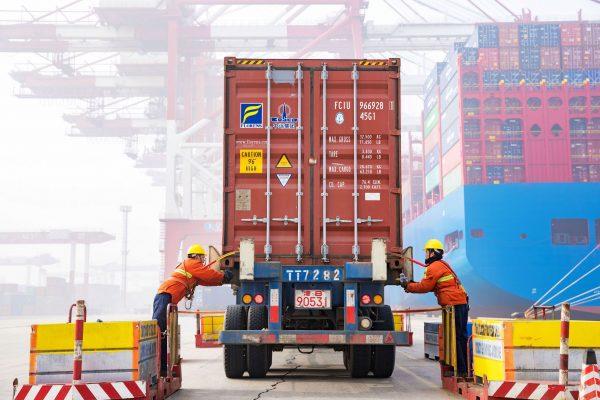 Workers prepare a container at the port in Qingdao, China’s eastern Shandong Province on Jan. 14, 2019. (STR/AFP/Getty Images)