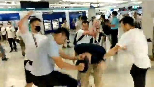 Men in white t-shirts and face masks attack anti-extradition bill demonstrators and reporters at a train station in Hong Kong, China, July 21, 2019, in this still image obtained from a social media live video. (Courtesy of Stand News/Social Media via Reuters)
