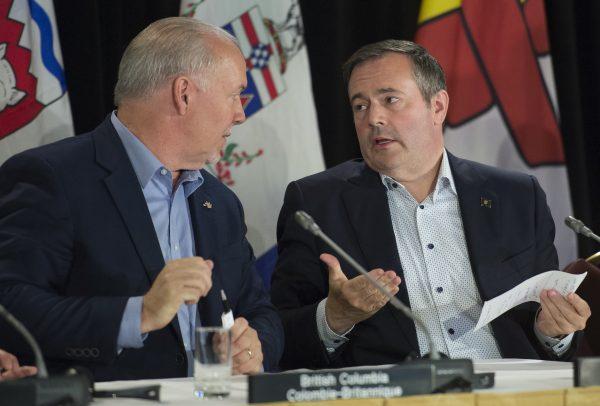 British Columbia Premier John Horgan speaks with Alberta Premier Jason Kenney following a closing news conference at a meeting of Canada's Premiers in Saskatoon, Sask., on July 11, 2019. (Jonathan Hayward/The Canadian Press)