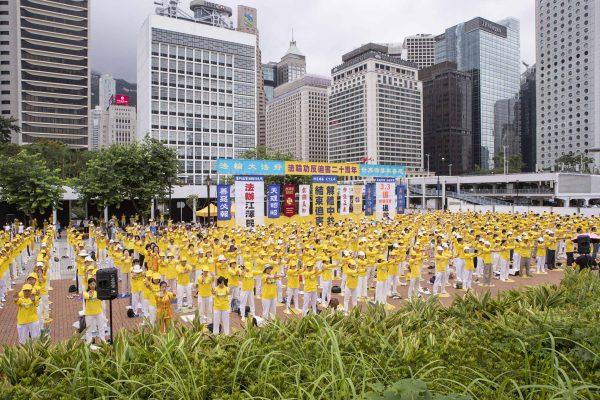 Falun Gong practitioners demonstrate the exercises of the mind-body meditative practice before a rally in Hong Kong on July 21, 2019. (Yu Kong/The Epoch Times)
