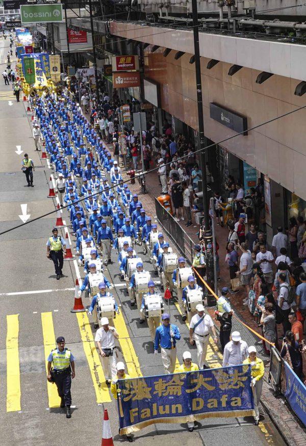 A marching band whose members are adherents of Falun Gong march in the streets of Hong Kong on July 21, 2019. (Yu Kong/The Epoch Times)