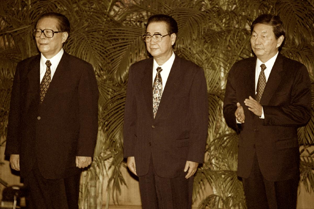 China's Communist Party chief Jiang Zemin (L) stands with fellow members of the party's newly-elected Politburo standing committee Premier Li Peng (C) and Vice Premier Zhu Rongji, who applauds during a photo opportunity to introduce his new colleagues, in Beijing, China on Sept. 19, 1997. (Will Burgess/Reuters)