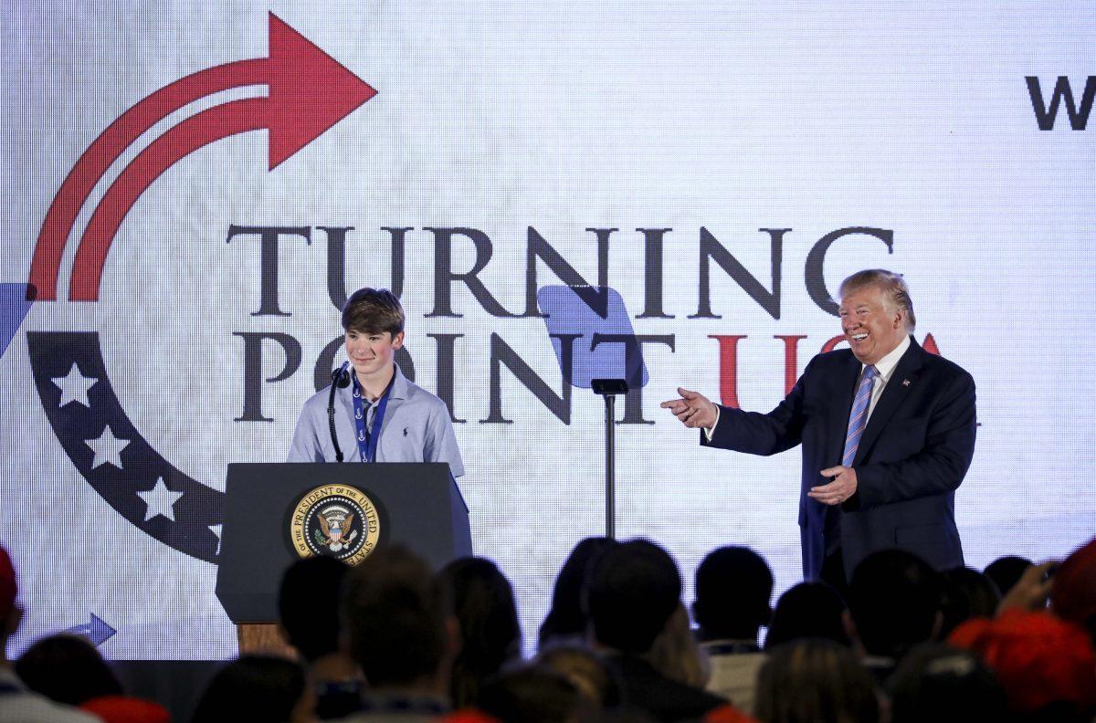 President Donald Trump listens to Ryan Zink as he speaks at the Turning Point USA Teen Student Action Summit in Washington on July 23, 2019. (Samira Bouaou/The Epoch Times)