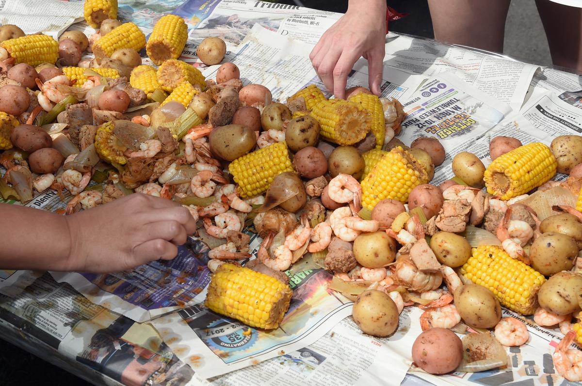 The cooked ingredients are usually strewn over a large table covered with butcher paper or newspaper. (Rick Diamond/Getty Images for Country Thunder USA)