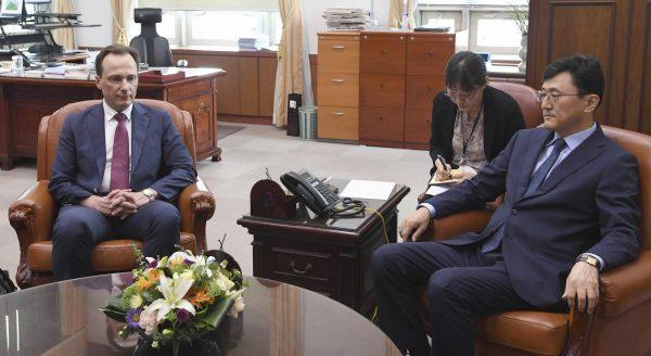 Acting Russian Ambassador to South Korea Maxim Volkov, left, and South Korean Deputy Minister for Political Affairs Yoon Soon-gu take their seats before their meeting at the Foreign ministry in Seoul, South Korea on July 23, 2019. (Kim Sung-do/Yonhap via AP)